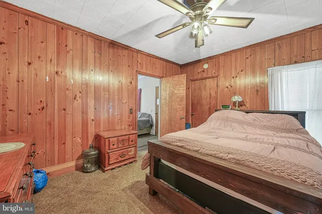 a bedroom with a large bed and a dresser
