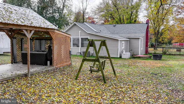 a view of a backyard with wooden fence