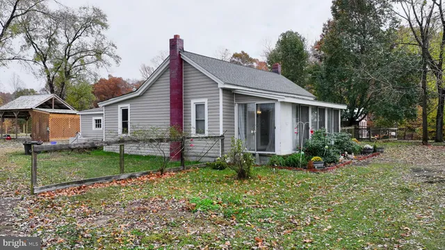 a view of swimming pool with a bench and trees