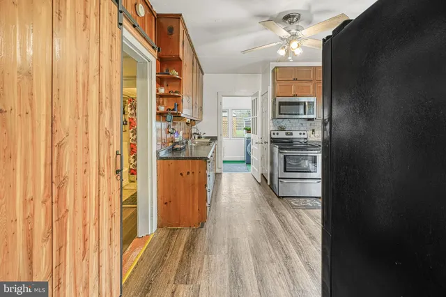 a kitchen with stainless steel appliances granite countertop a refrigerator and a stove top oven