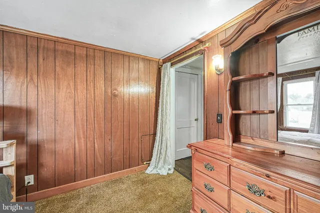 a spacious bedroom with a bed and a chandelier
