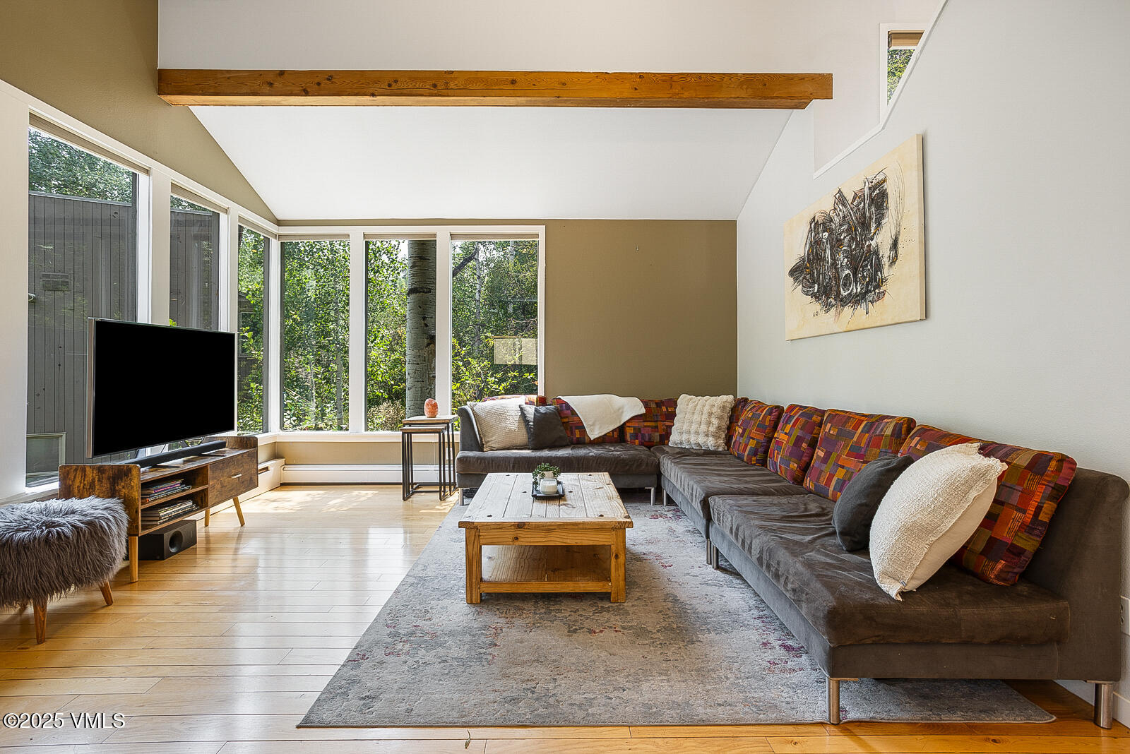 1490 Buffehr Creek Road, Unit A44 Vail, CO 81657 - Photo 1 of 39 a living room with furniture and a flat screen tv