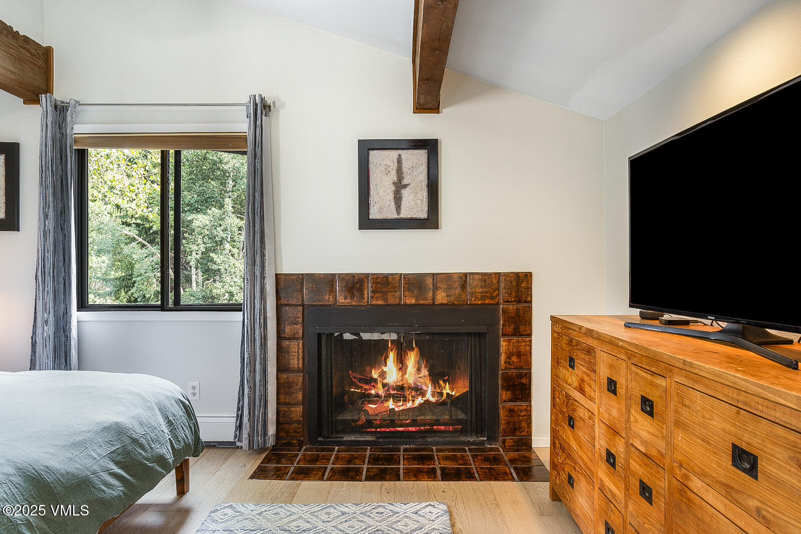1490 Buffehr Creek Road, Unit A44 Vail, CO 81657 - Photo 15 of 39 a living room with furniture a flat screen tv and a fireplace