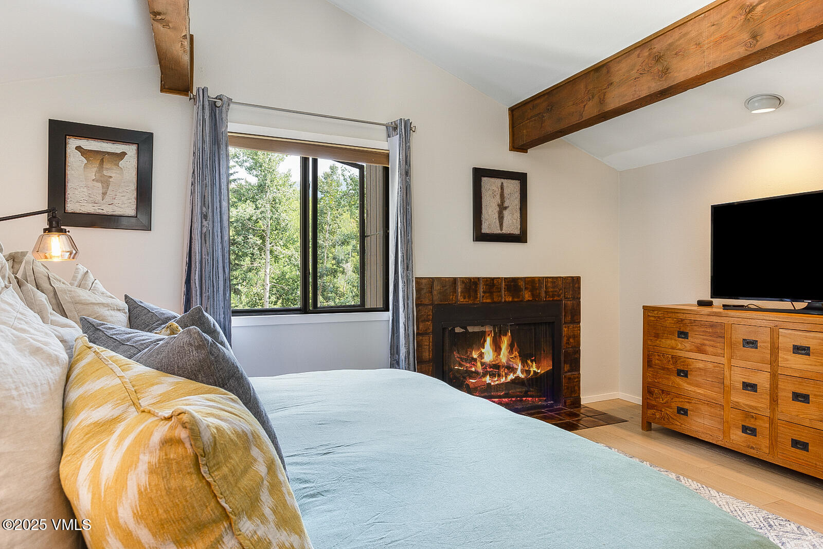 1490 Buffehr Creek Road, Unit A44 Vail, CO 81657 - Photo 17 of 39 a bedroom with bed and a fireplace