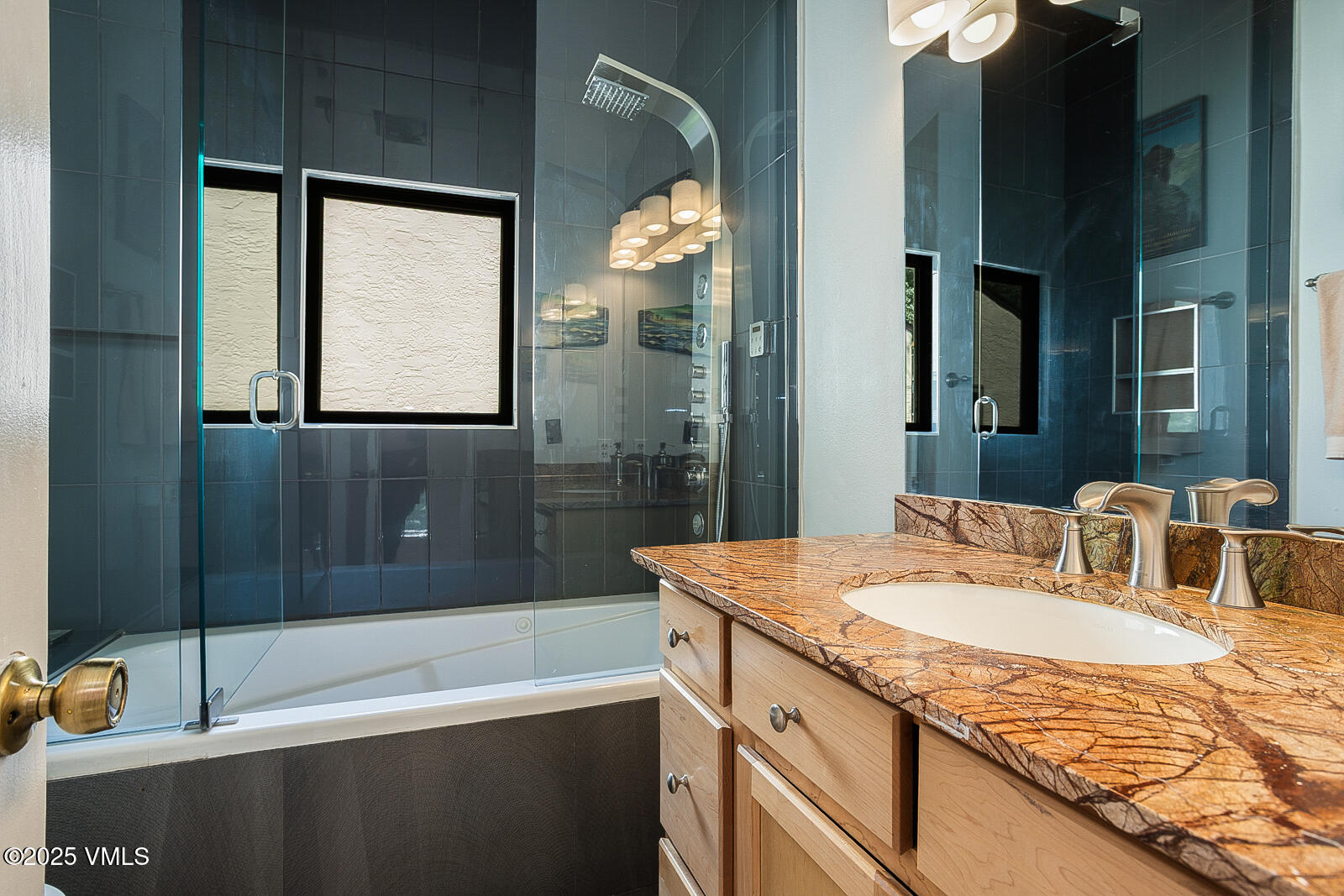 1490 Buffehr Creek Road, Unit A44 Vail, CO 81657 - Photo 18 of 39 a bathroom with a granite countertop sink and a mirror