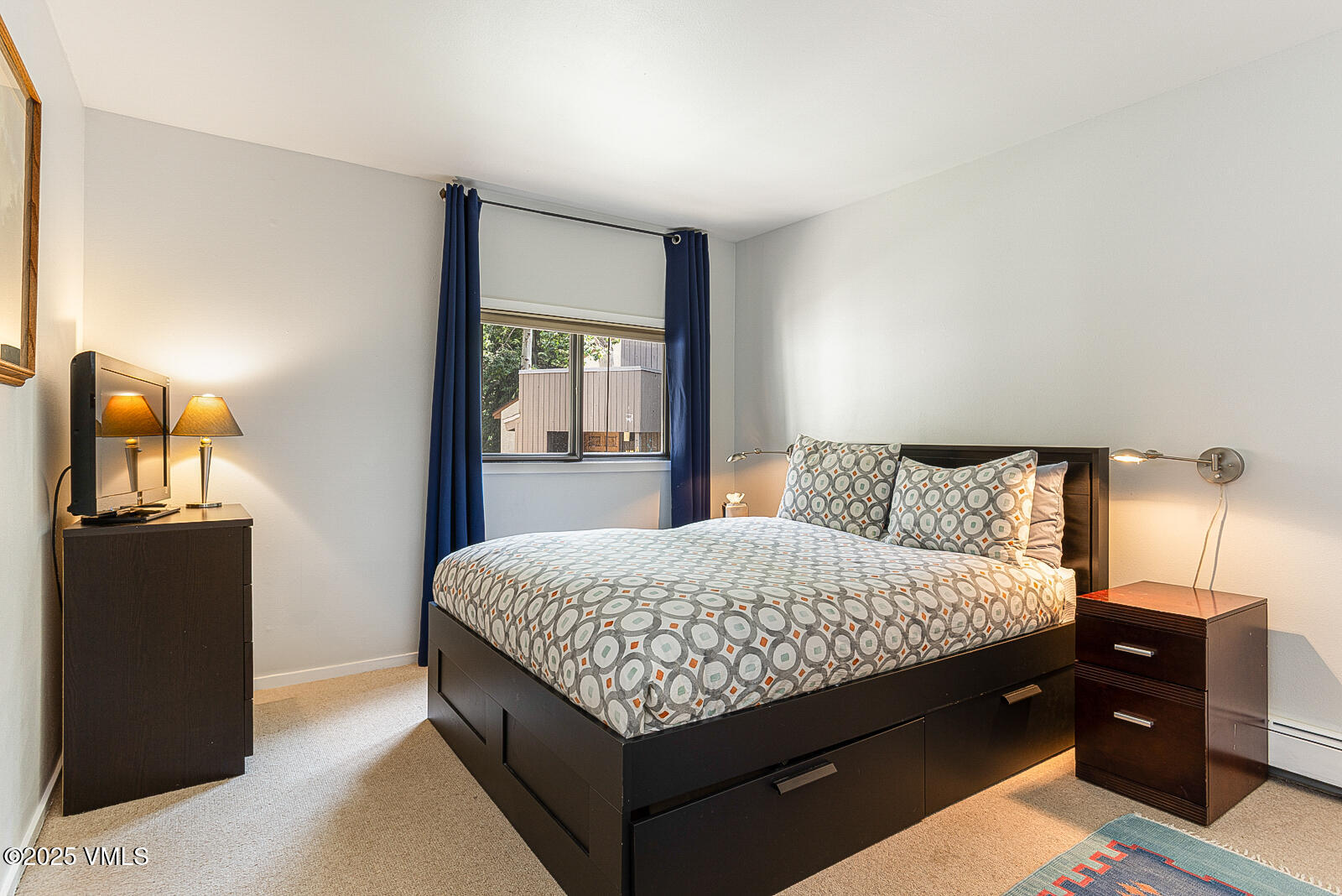 1490 Buffehr Creek Road, Unit A44 Vail, CO 81657 - Photo 19 of 39 a bedroom with a bed and wooden floor