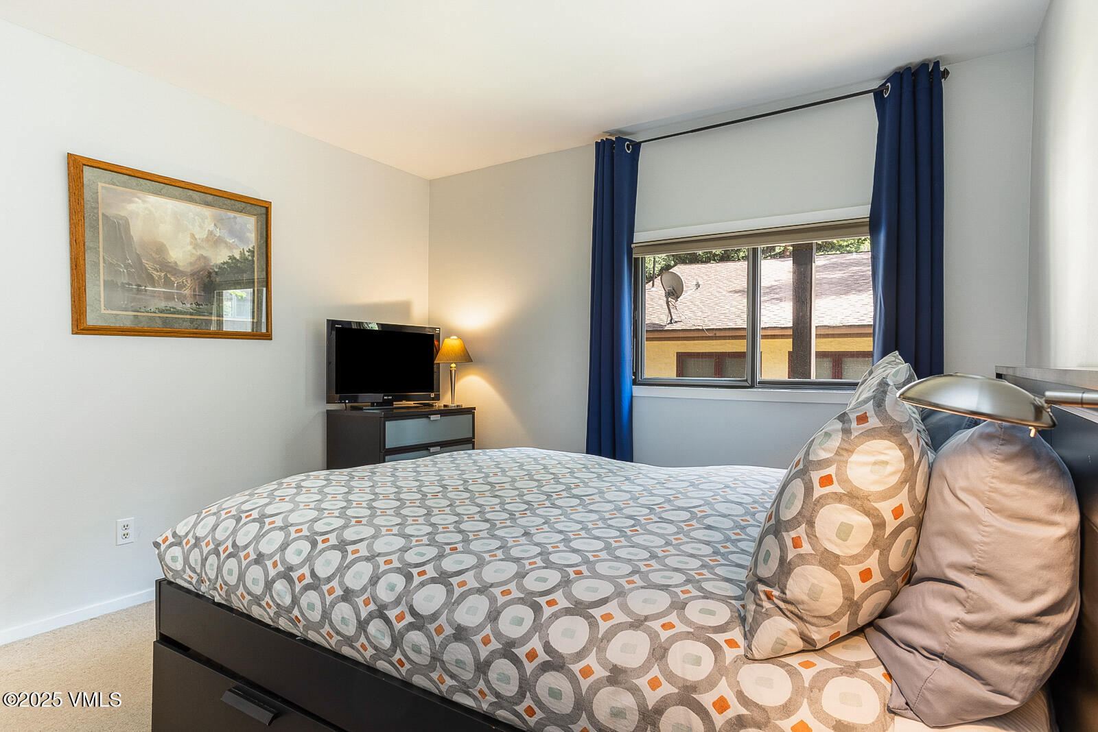 1490 Buffehr Creek Road, Unit A44 Vail, CO 81657 - Photo 20 of 39 a bedroom with a bed and a flat screen tv