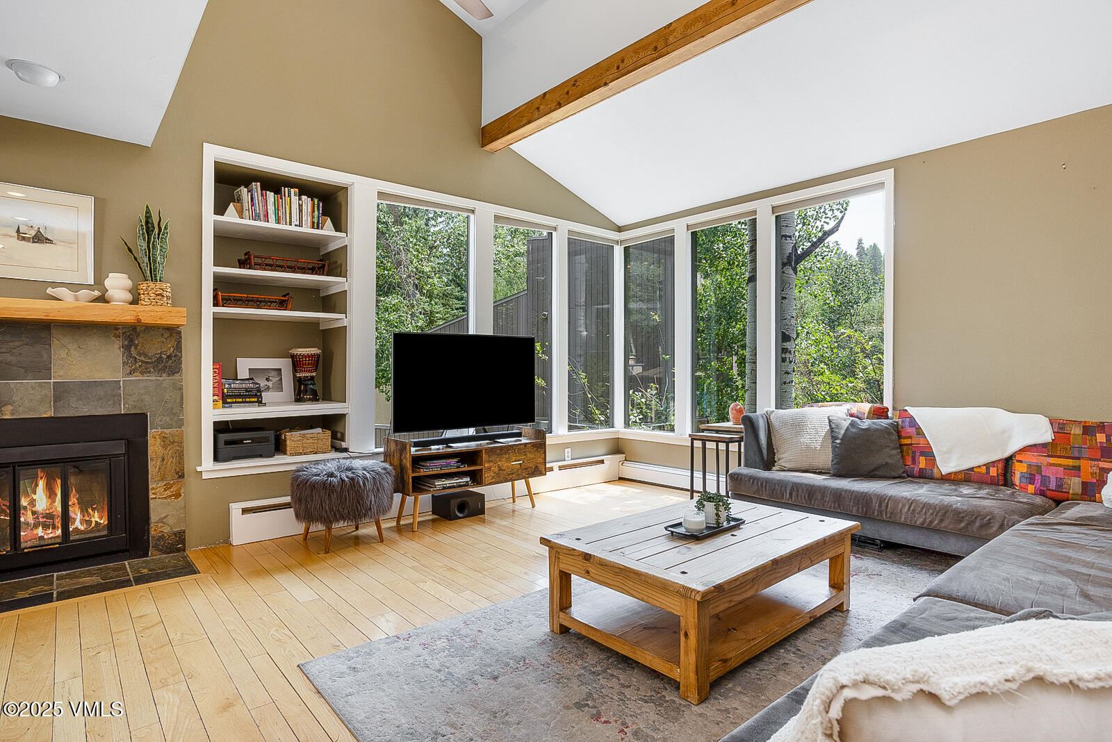 1490 Buffehr Creek Road, Unit A44 Vail, CO 81657 - Photo 2 of 39 a living room with fireplace furniture and a flat screen tv