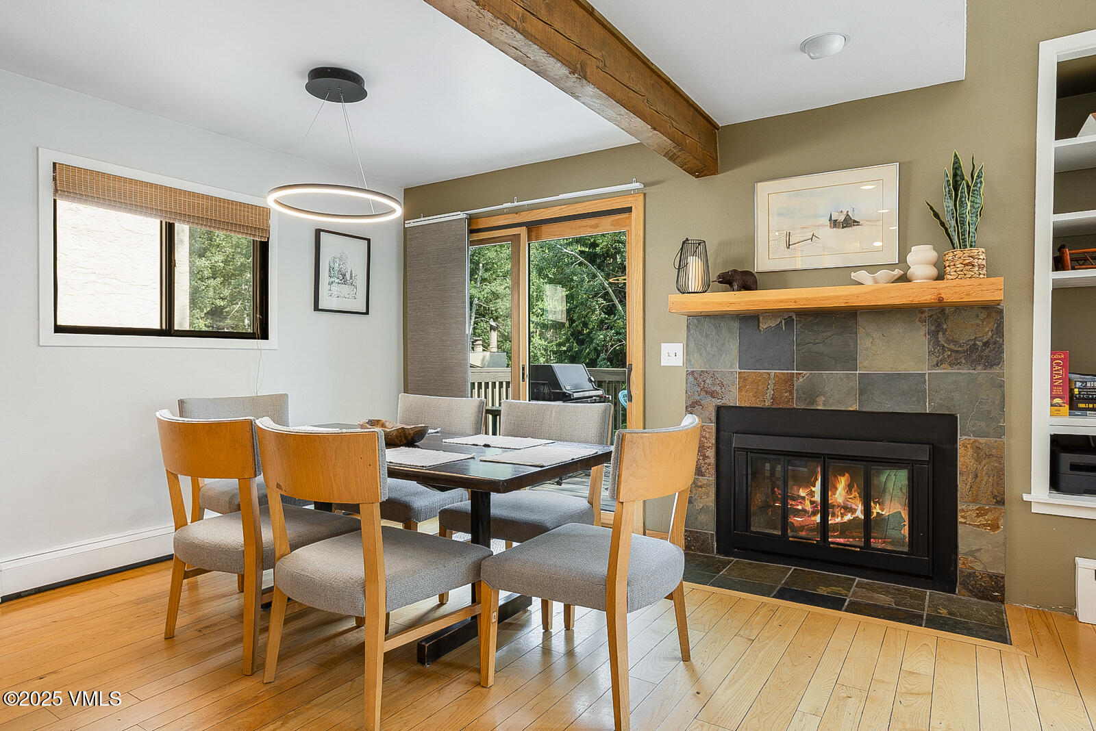 1490 Buffehr Creek Road, Unit A44 Vail, CO 81657 - Photo 6 of 39 a dining room with furniture and a fireplace