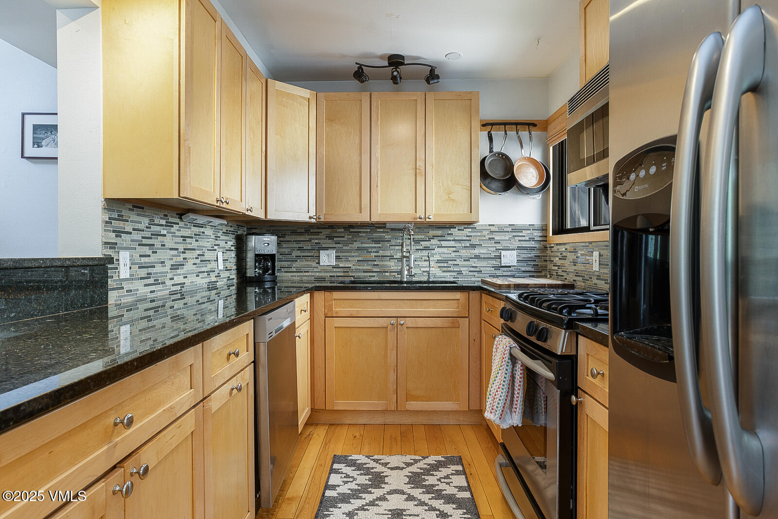 1490 Buffehr Creek Road, Unit A44 Vail, CO 81657 - Photo 10 of 39 a kitchen with stainless steel appliances granite countertop a stove a sink and a refrigerator