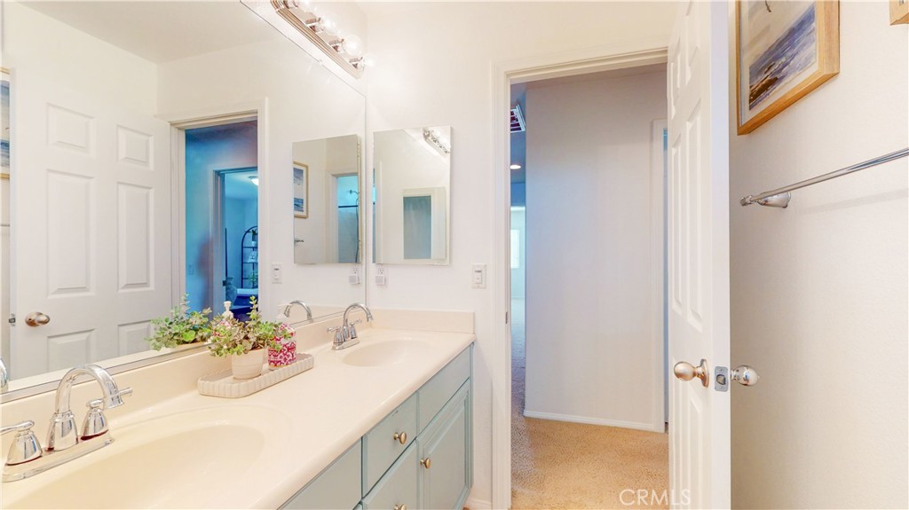 1279 Longbranch Road San Jacinto, CA 92582 - Photo 22 of 35 a bathroom with a sink and a mirror