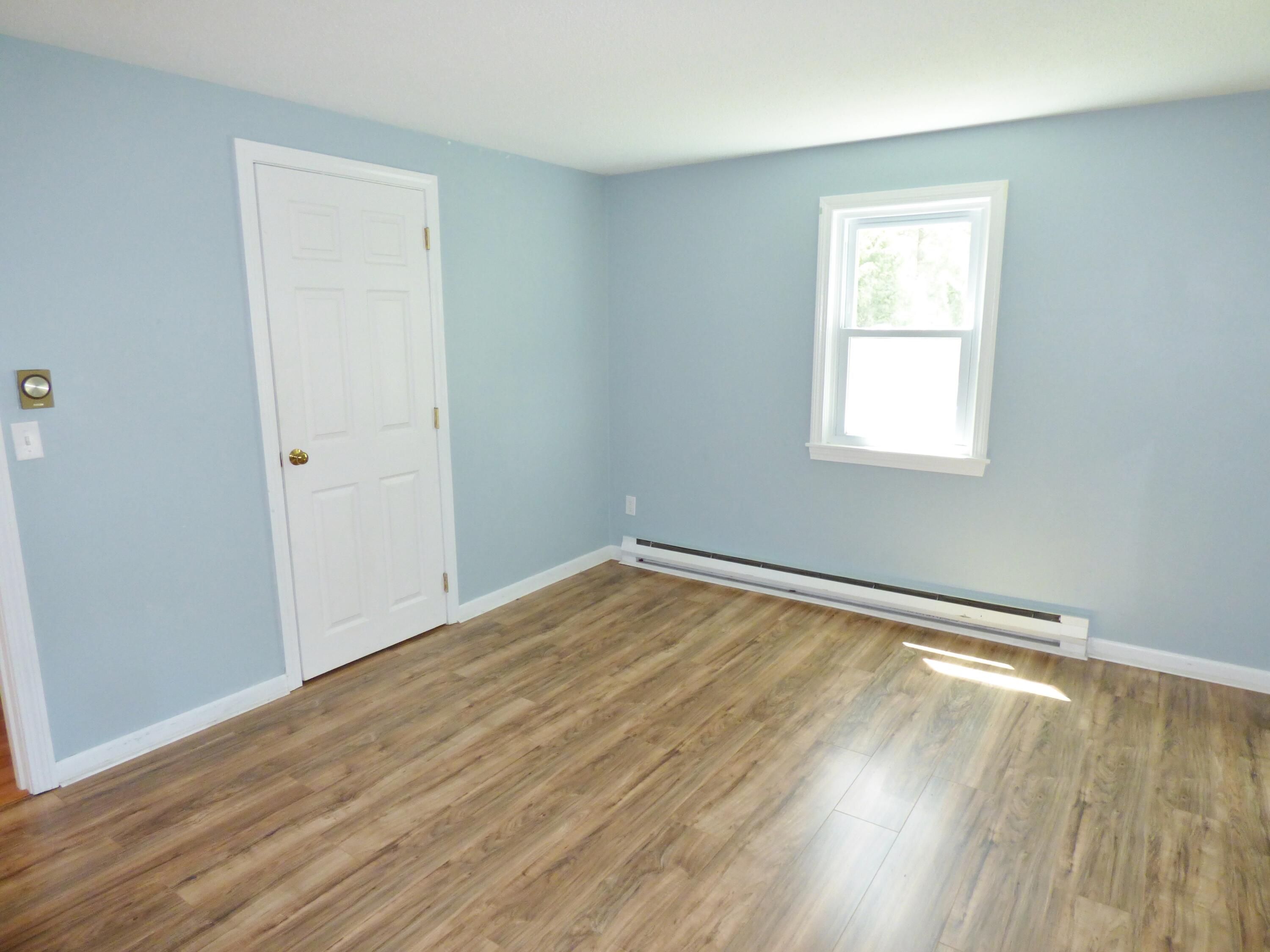 18 Limerick Court Centerville, MA 02632 - Photo 12 of 24 an empty room with wooden floor and windows