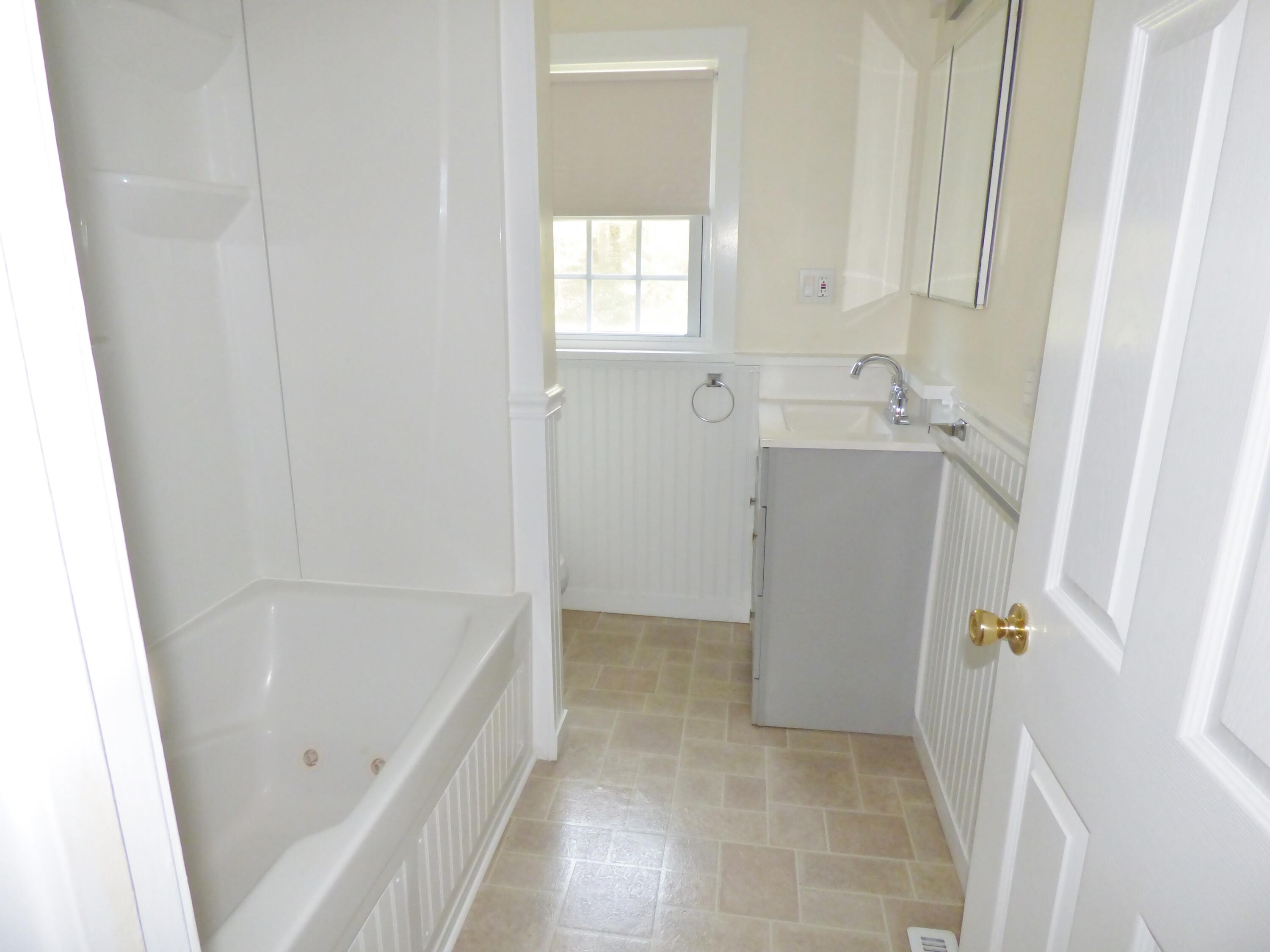 18 Limerick Court Centerville, MA 02632 - Photo 15 of 24 a bathroom with a tub sink and a mirror