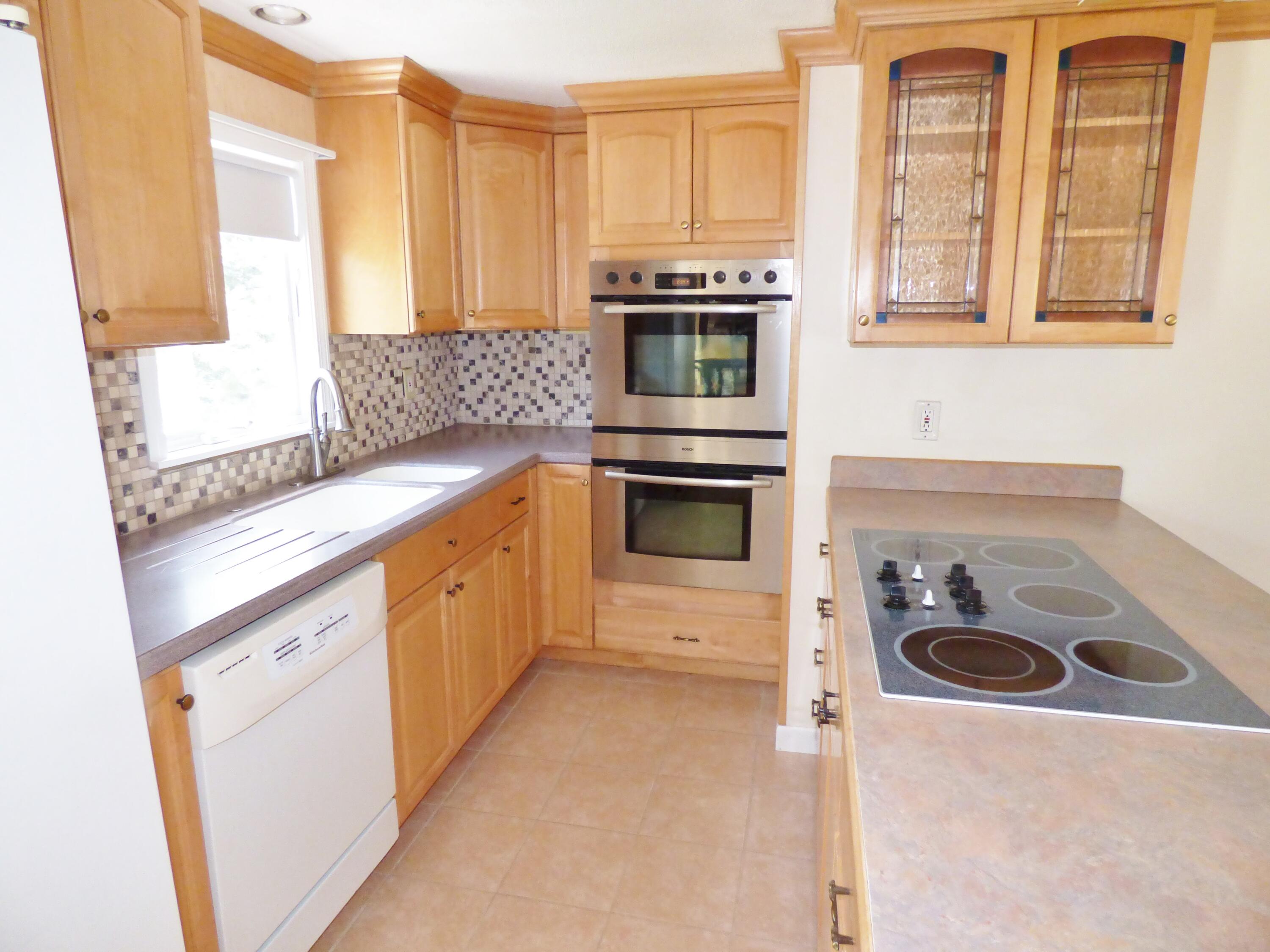 18 Limerick Court Centerville, MA 02632 - Photo 4 of 24 a kitchen with granite countertop a sink and a stove top oven