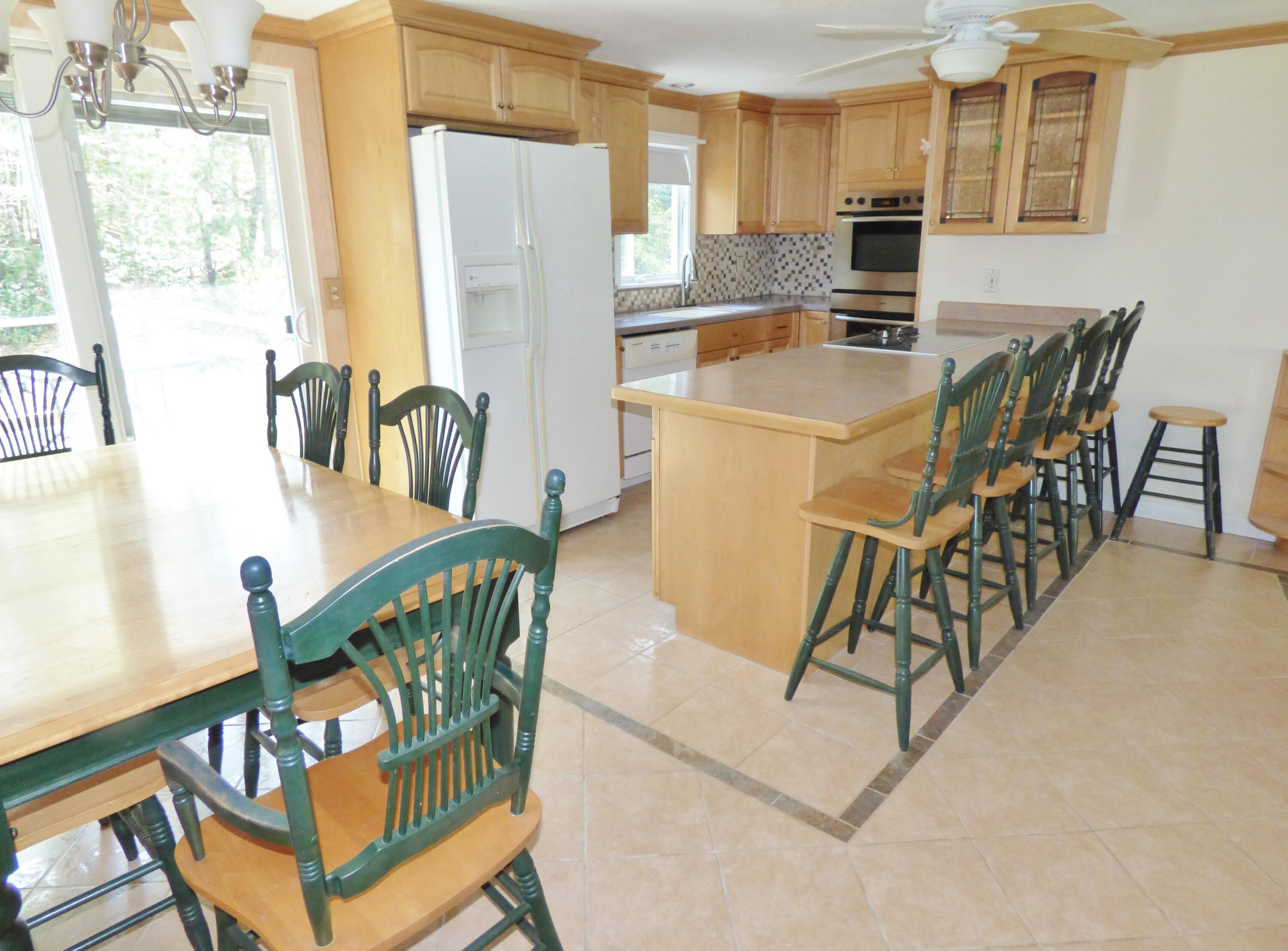 18 Limerick Court Centerville, MA 02632 - Photo 5 of 24 a view of a dining room with furniture window and outside view