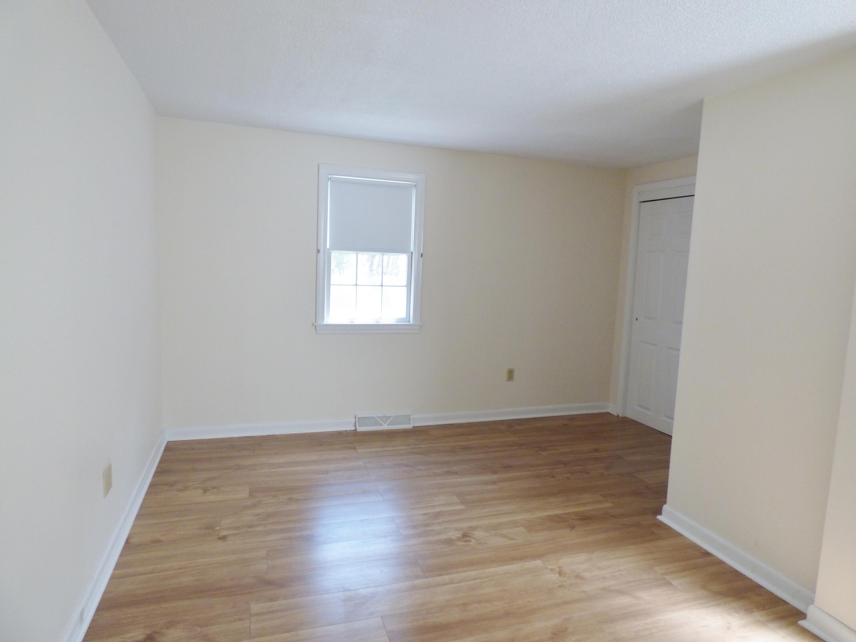 18 Limerick Court Centerville, MA 02632 - Photo 10 of 24 an empty room with wooden floor and windows