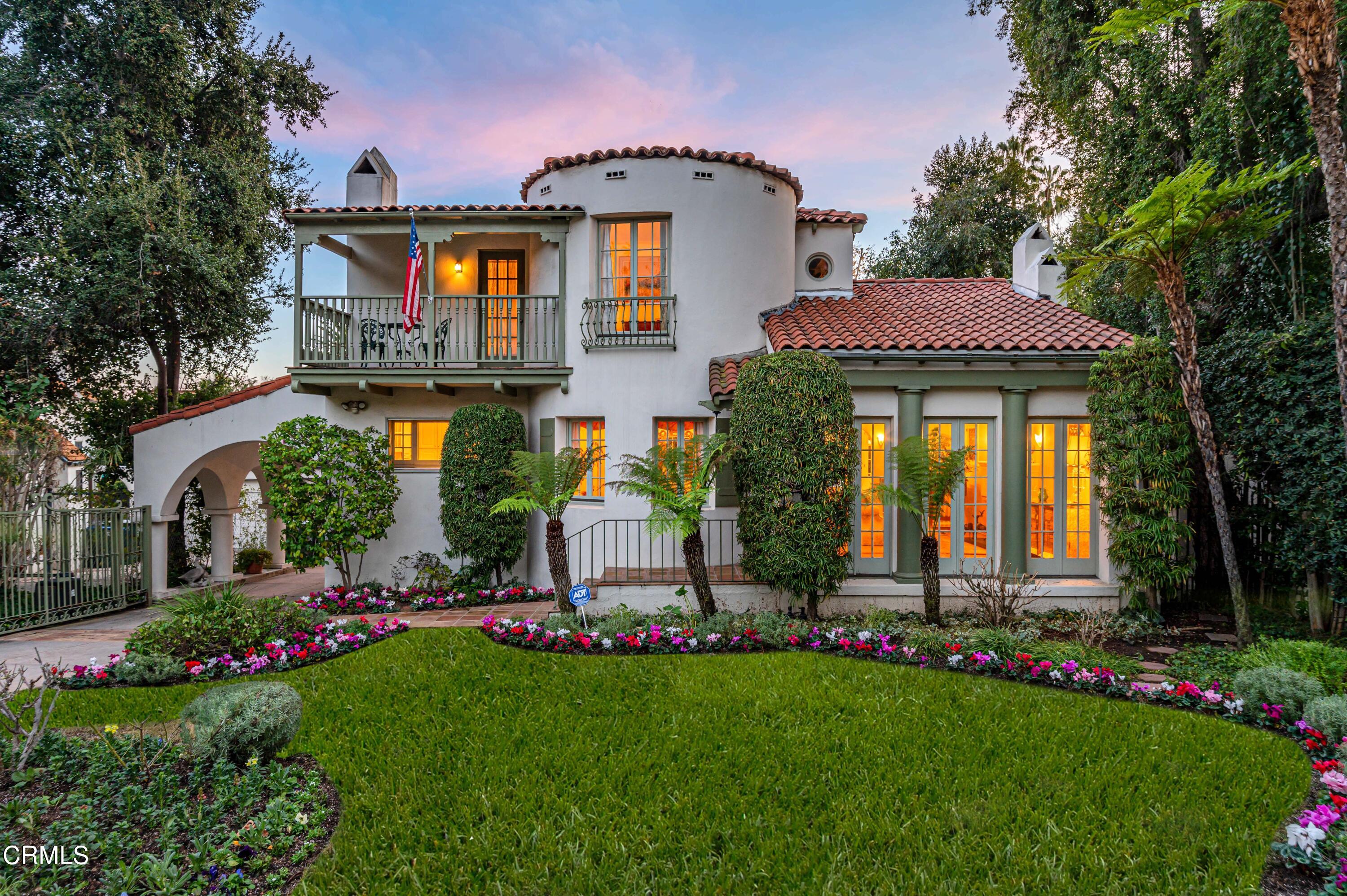 a front view of house with a garden