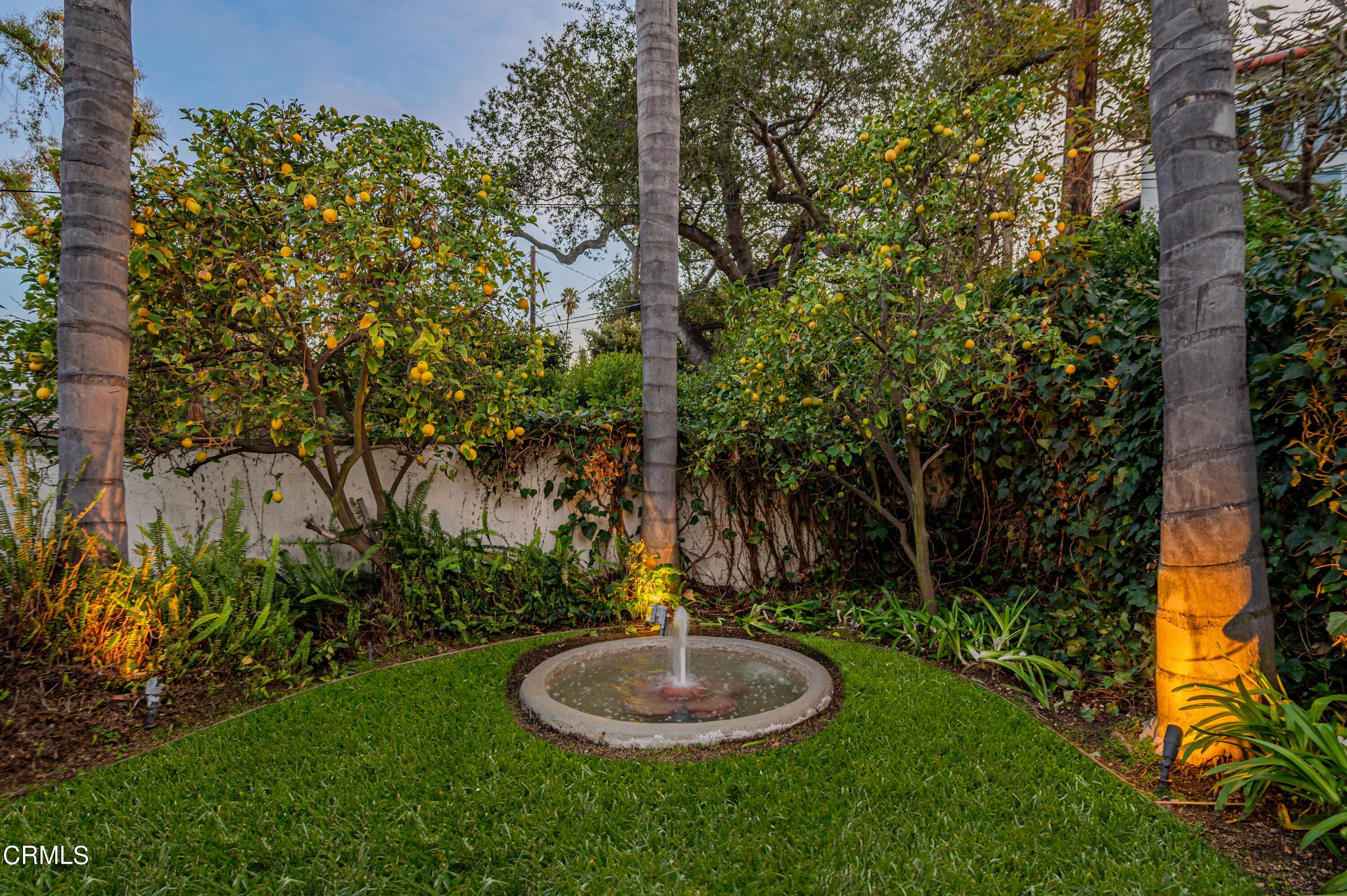 818 Old Mill Road Pasadena, CA 91108 - Photo 63 of 71 a backyard of a house with a fountain and a tree