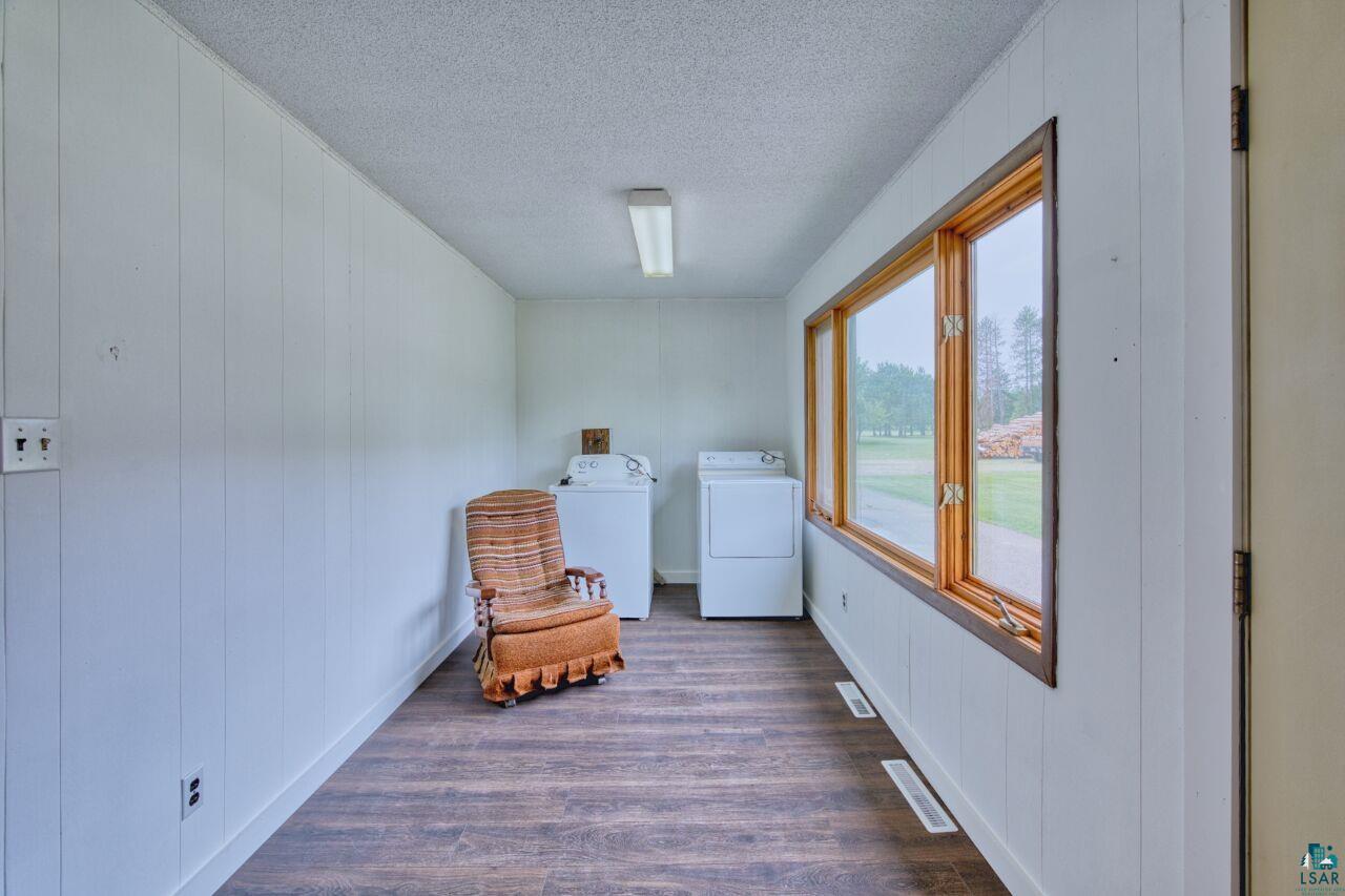 4755 Judd Road Gilbert, MN 55741 - Photo 15 of 50 Living area featuring washer and clothes dryer, a textured ceiling, and dark wood-style flooring