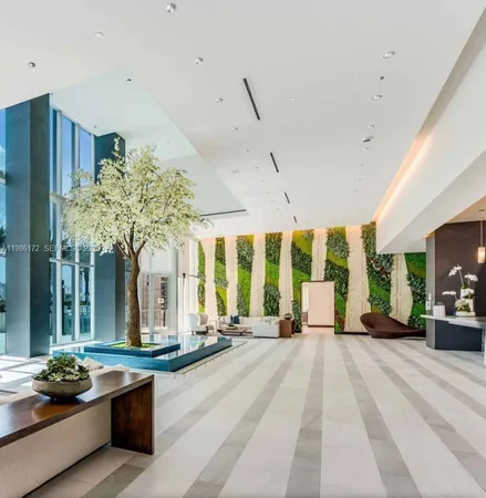 a lobby with furniture and large windows