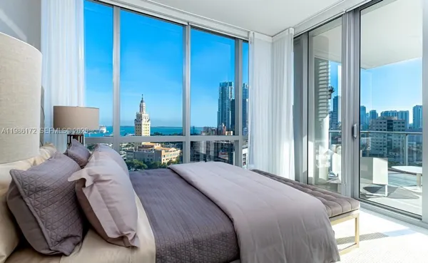 a bedroom with bed and a table