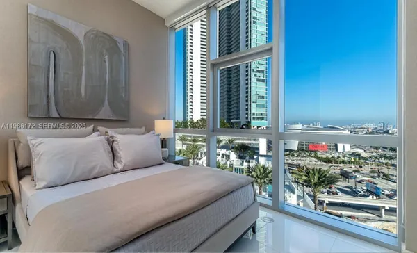 a bedroom with a bed and windows