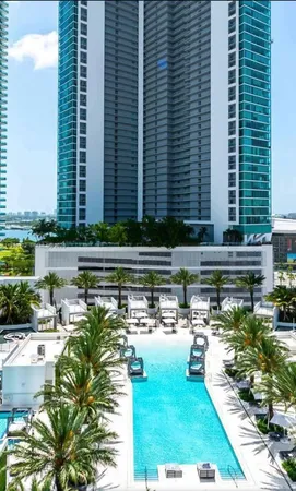 a swimming pool with outdoor seating and plants
