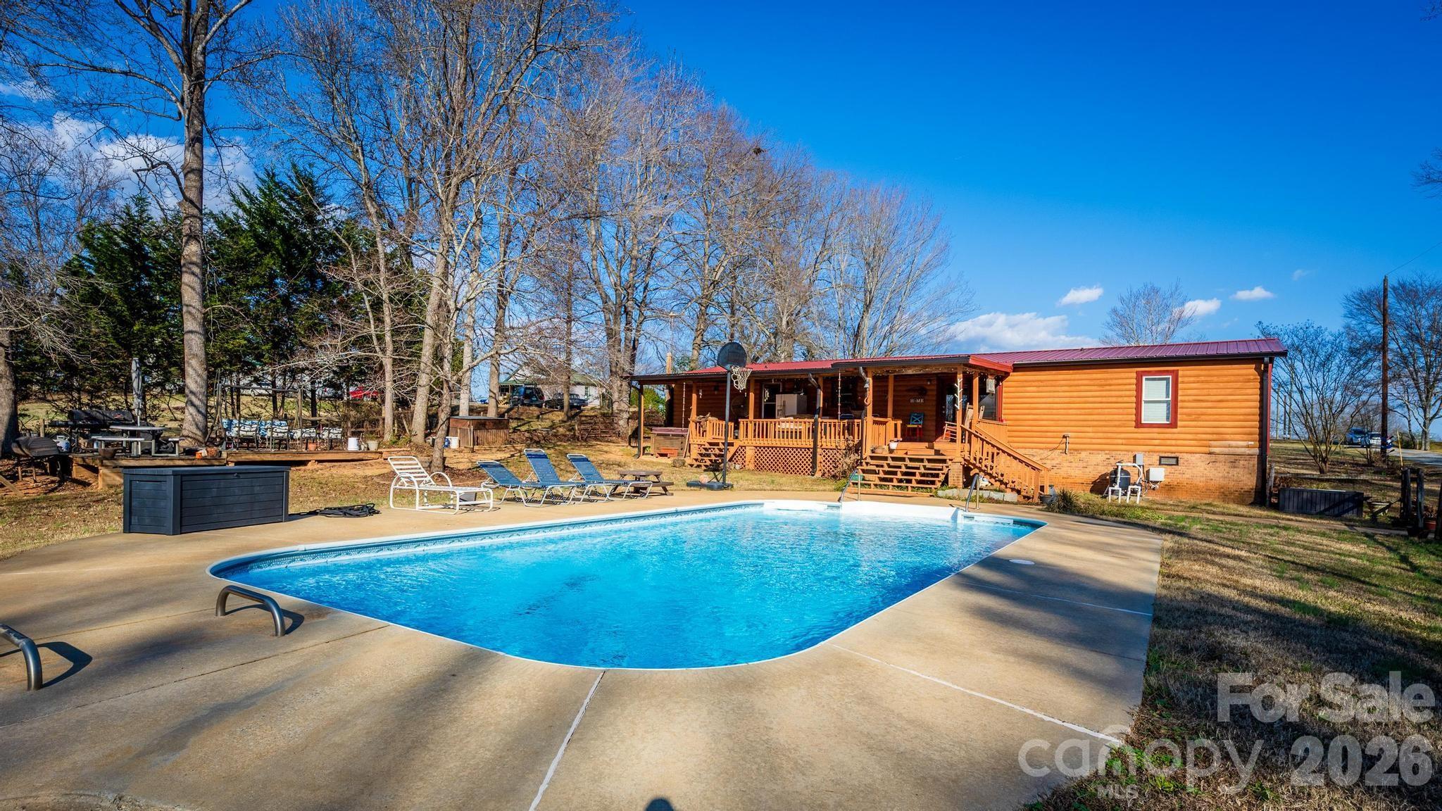 11443 Mooresville Road Davidson, NC 28036 - Photo 29 of 47 a view of a swimming pool with an outdoor seating