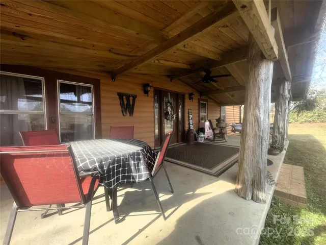 a view of a patio with table and chairs with wooden floor