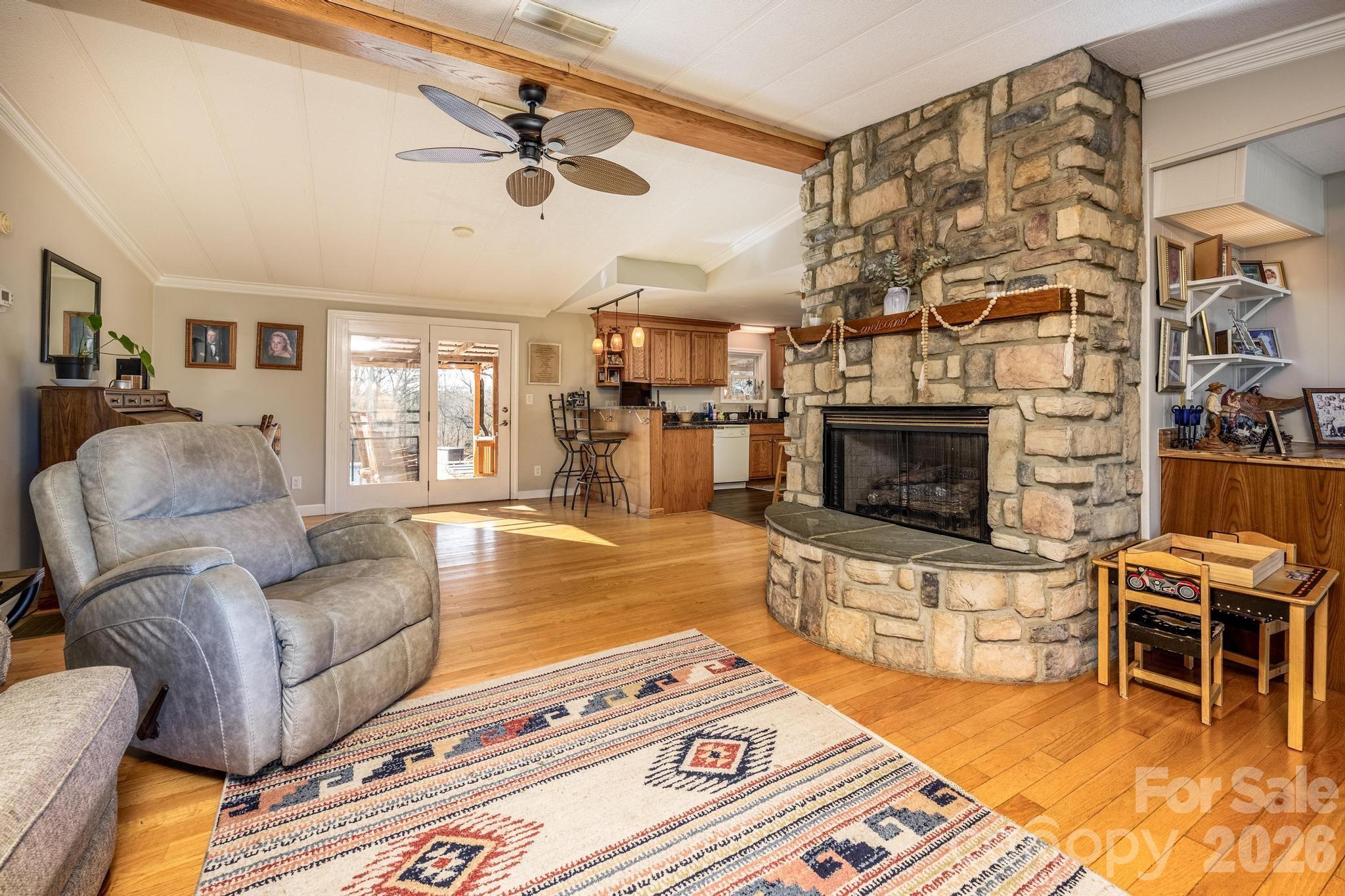 11443 Mooresville Road Davidson, NC 28036 - Photo 32 of 47 a living room with furniture a flat screen tv and a fireplace