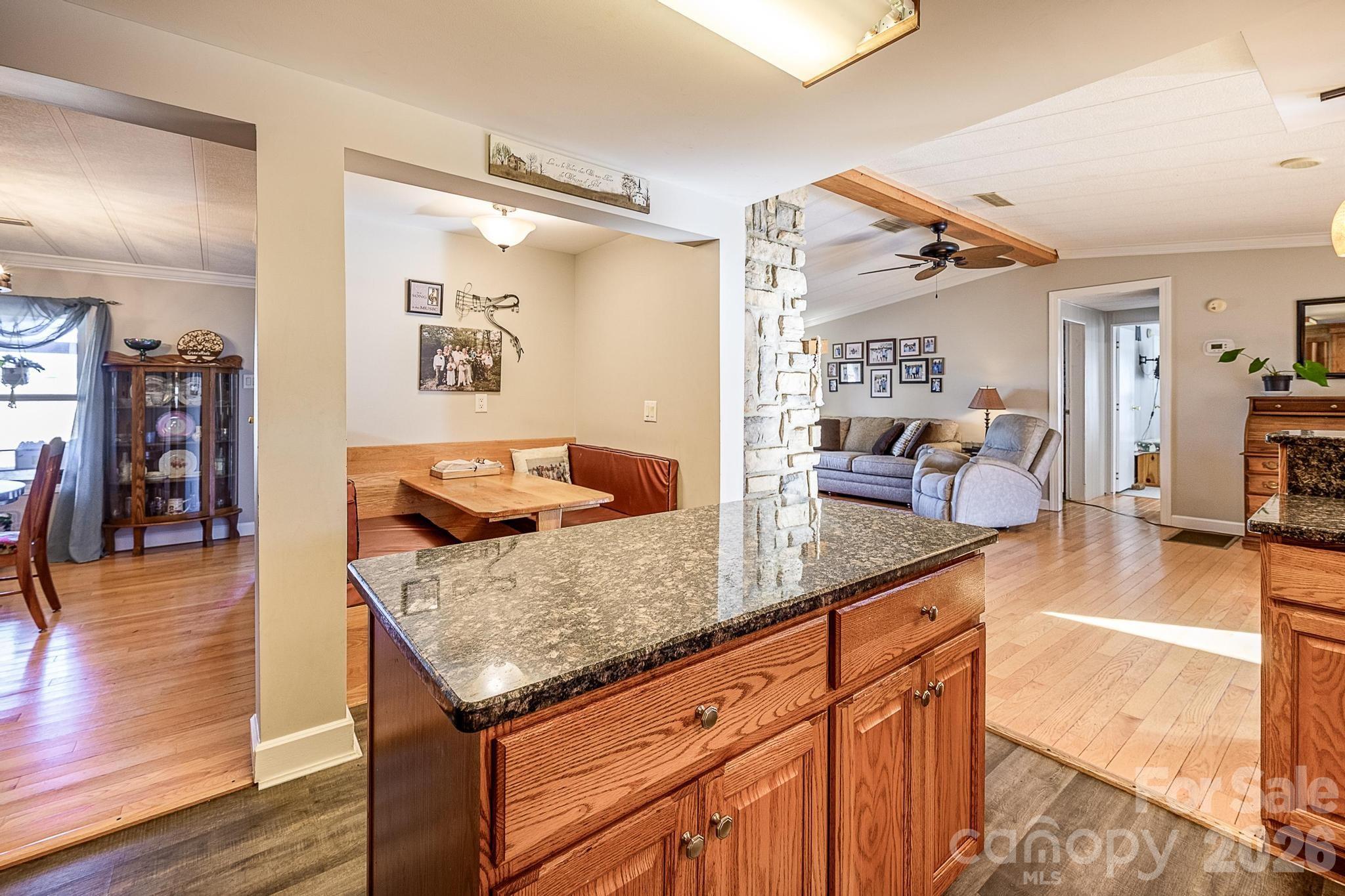 11443 Mooresville Road Davidson, NC 28036 - Photo 36 of 47 a living room with stainless steel appliances granite countertop furniture a couch and a large mirror with wooden floor
