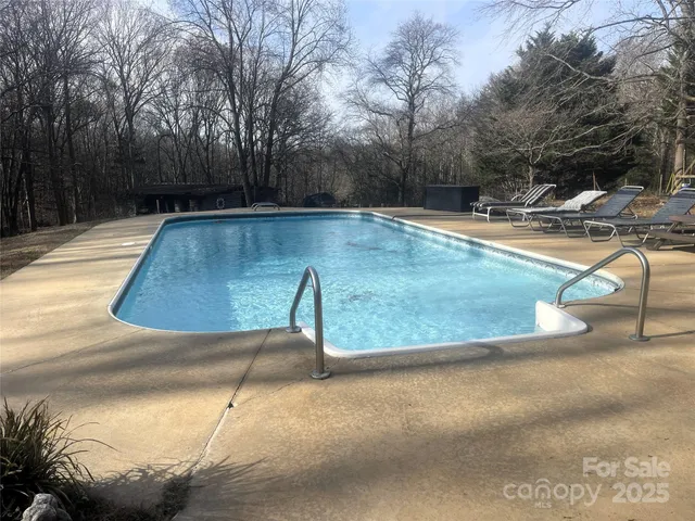 a view of a swimming pool with a yard