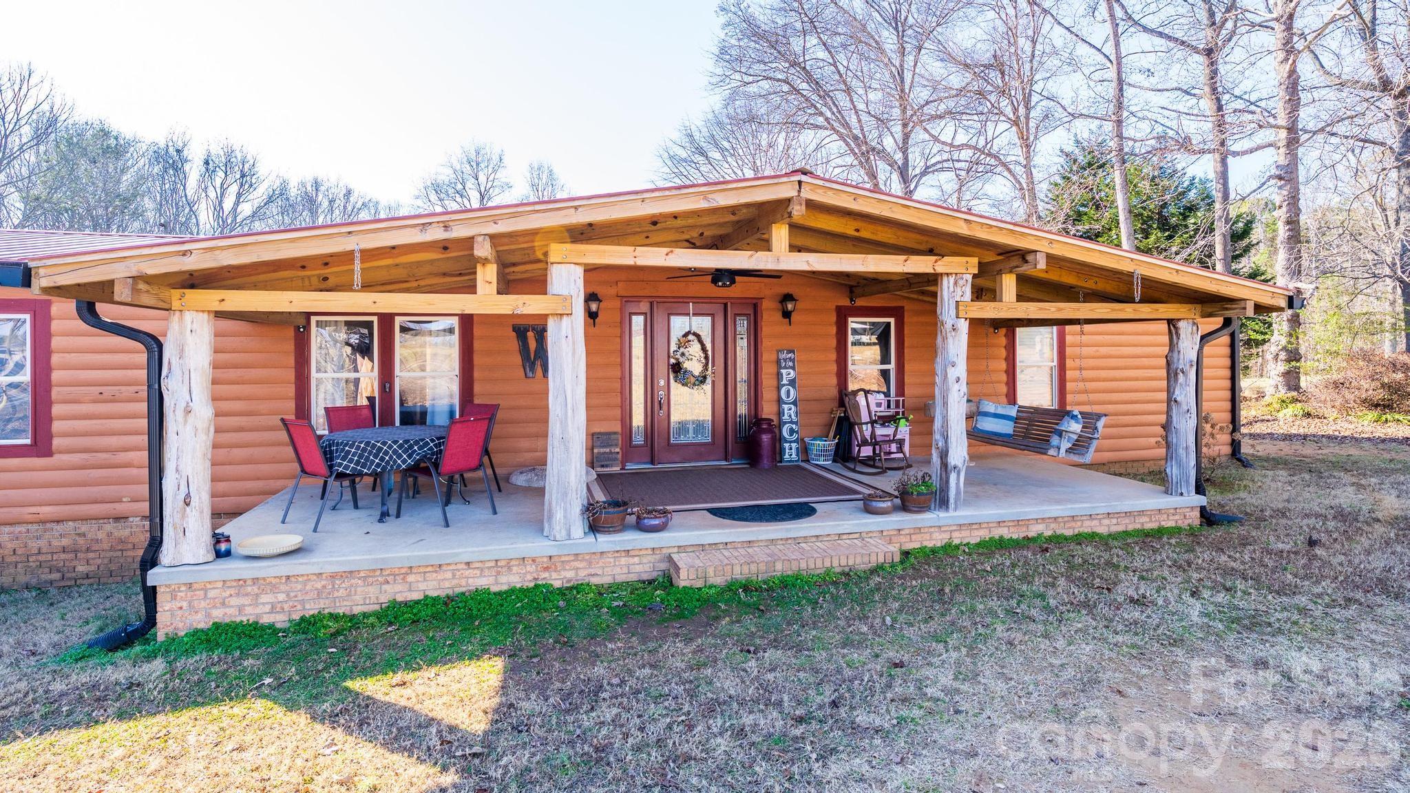 11443 Mooresville Road Davidson, NC 28036 - Photo 5 of 47 a view of a chair and table in backyard