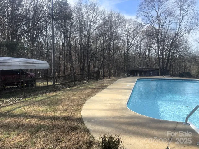 a swimming pool with wooden fence