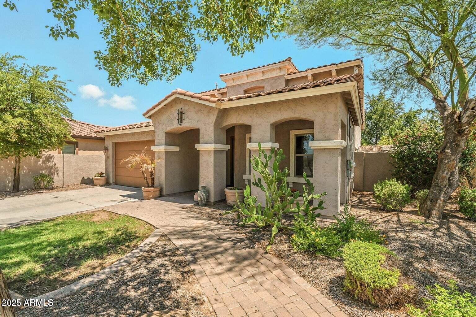 7169 South Dodane Court Gilbert, AZ 85298 - Photo 1 of 23 a view of a house with a yard and potted plants