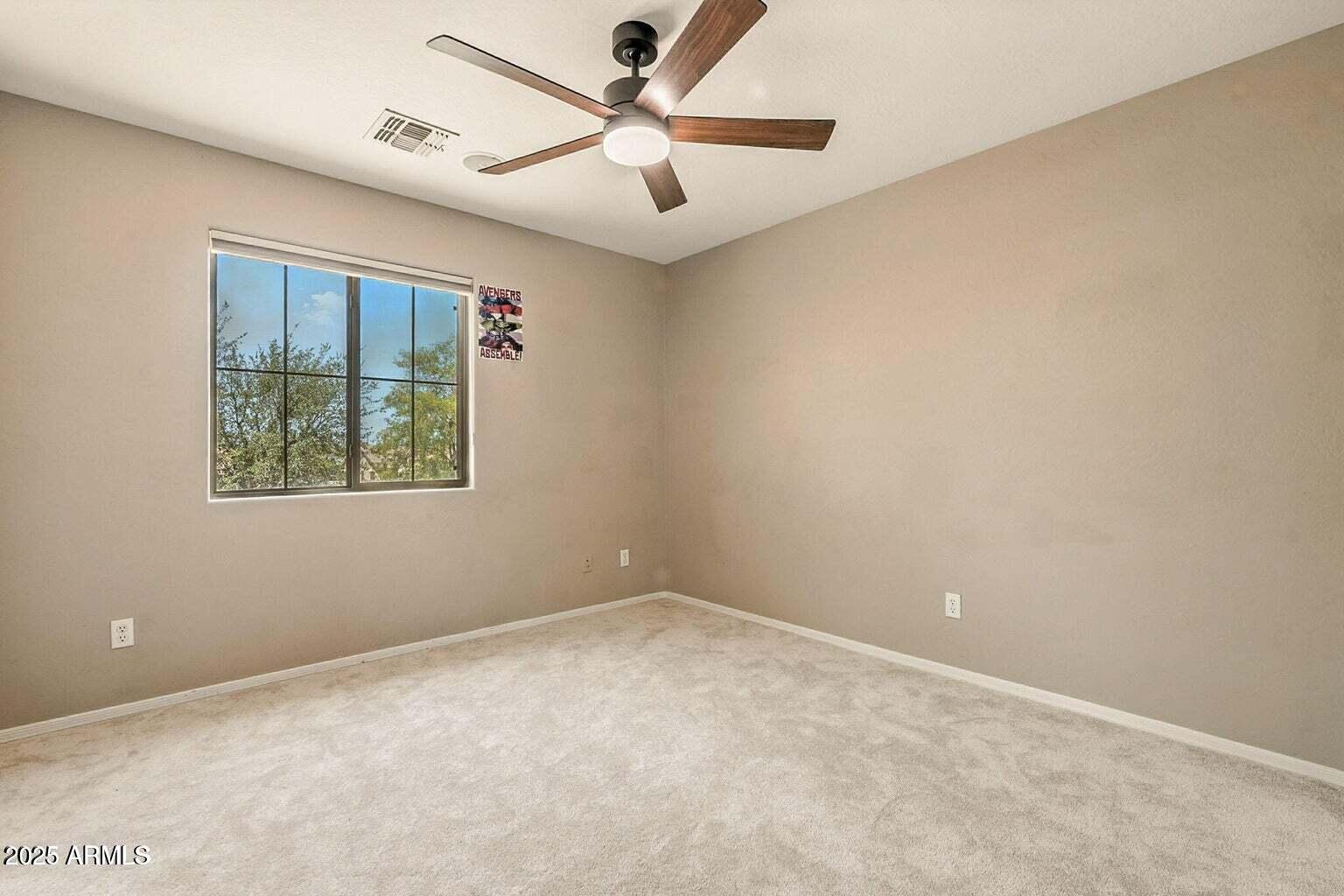 7169 South Dodane Court Gilbert, AZ 85298 - Photo 14 of 23 an empty room with a window and a ceiling fan