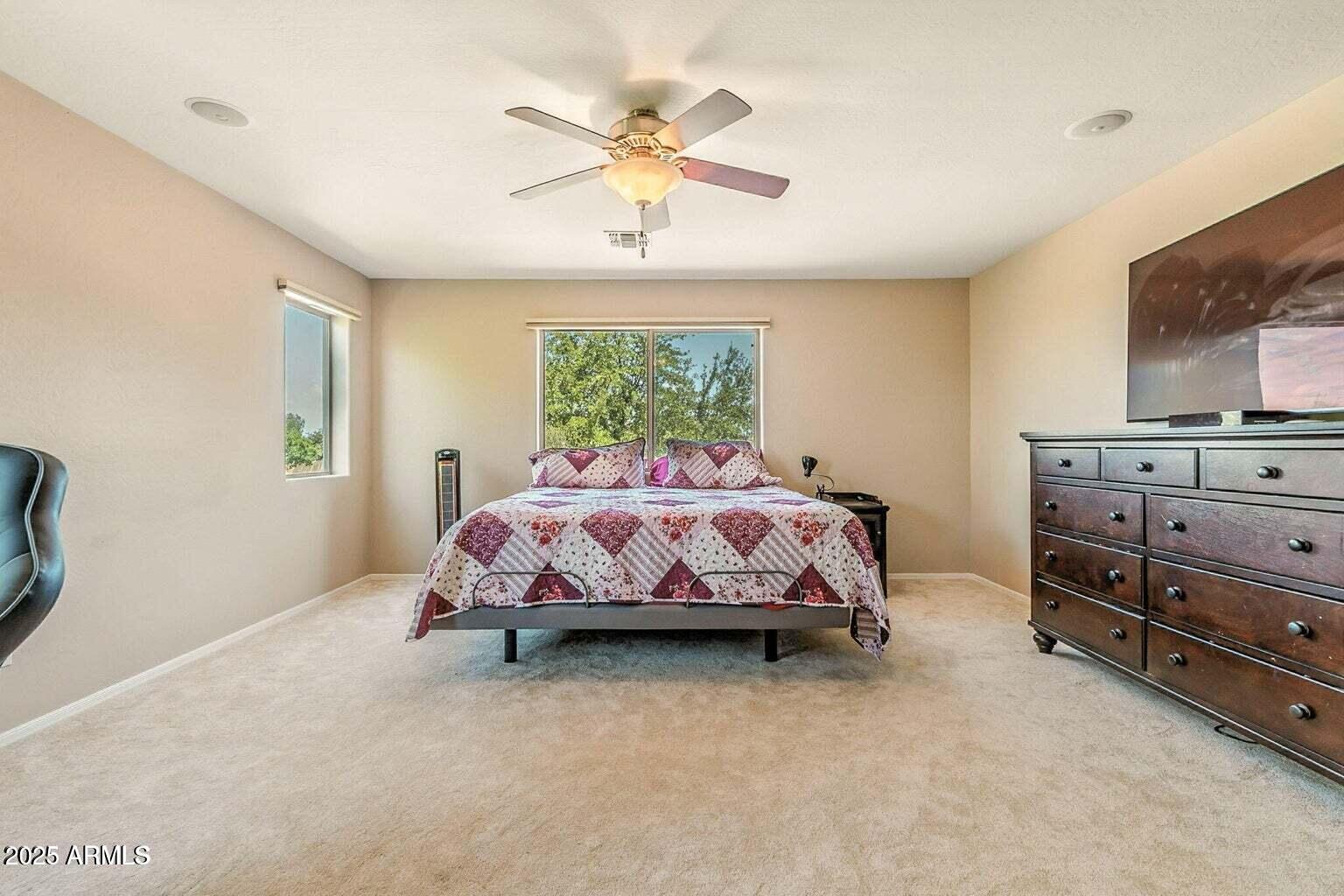 7169 South Dodane Court Gilbert, AZ 85298 - Photo 17 of 23 a bed sitting in a spacious bedroom next to a window
