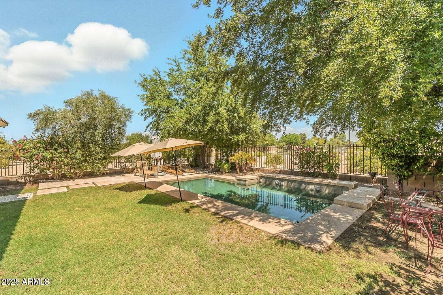 7169 South Dodane Court Gilbert, AZ 85298 - Photo 23 of 23 a view of swimming pool with lawn chairs and plants