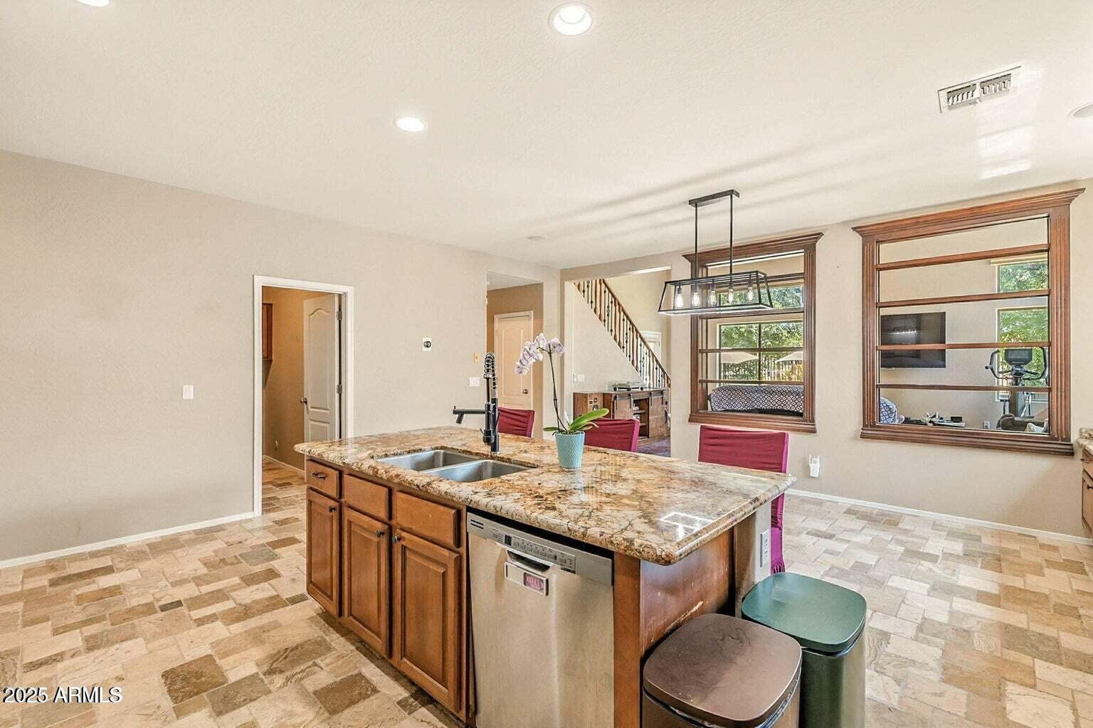 7169 South Dodane Court Gilbert, AZ 85298 - Photo 6 of 23 a open kitchen with a stove a sink dishwasher and cabinets with wooden floor