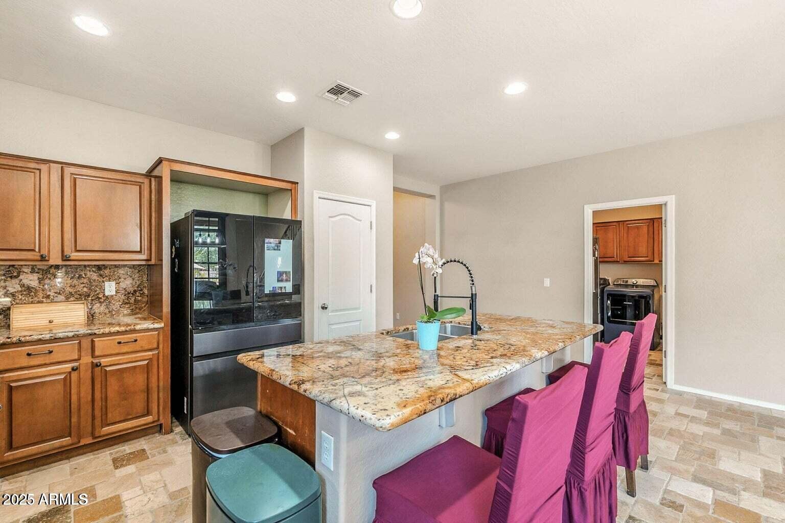 7169 South Dodane Court Gilbert, AZ 85298 - Photo 7 of 23 a kitchen with a table chairs and wooden floor