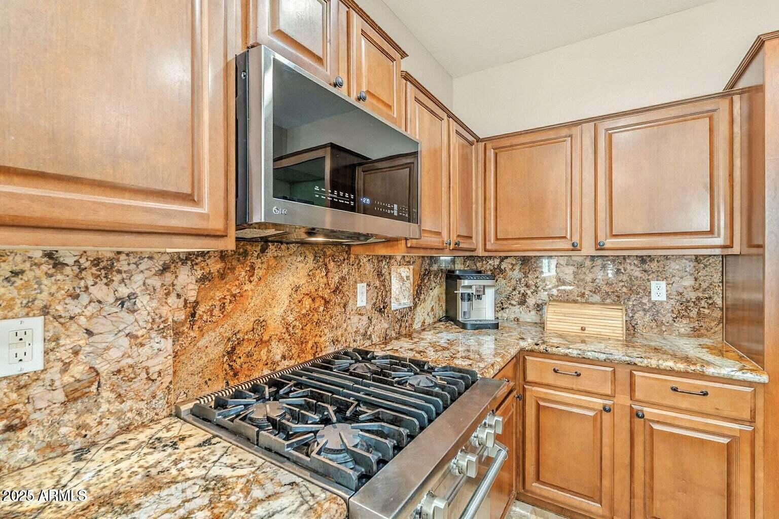 7169 South Dodane Court Gilbert, AZ 85298 - Photo 9 of 23 a kitchen with sink a stove and cabinets
