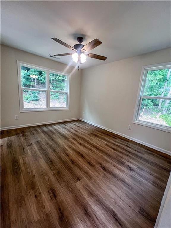6590 Old Still Trail Gainesville, GA 30506 - Photo 11 of 17 a view of an empty room with wooden floor and a window