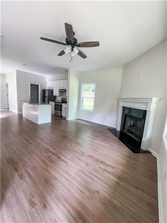 6590 Old Still Trail Gainesville, GA 30506 - Photo 2 of 17 a view of empty room with wooden floor and fireplace