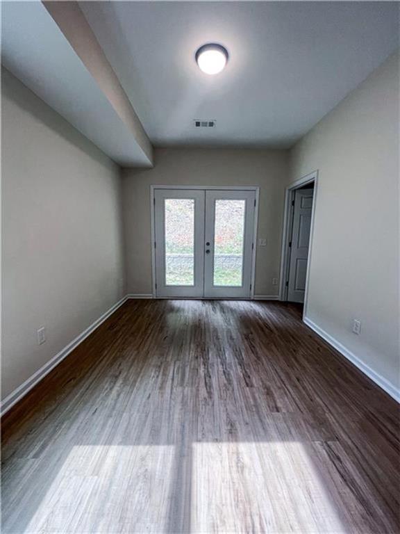 6590 Old Still Trail Gainesville, GA 30506 - Photo 6 of 17 an empty room with wooden floor and windows