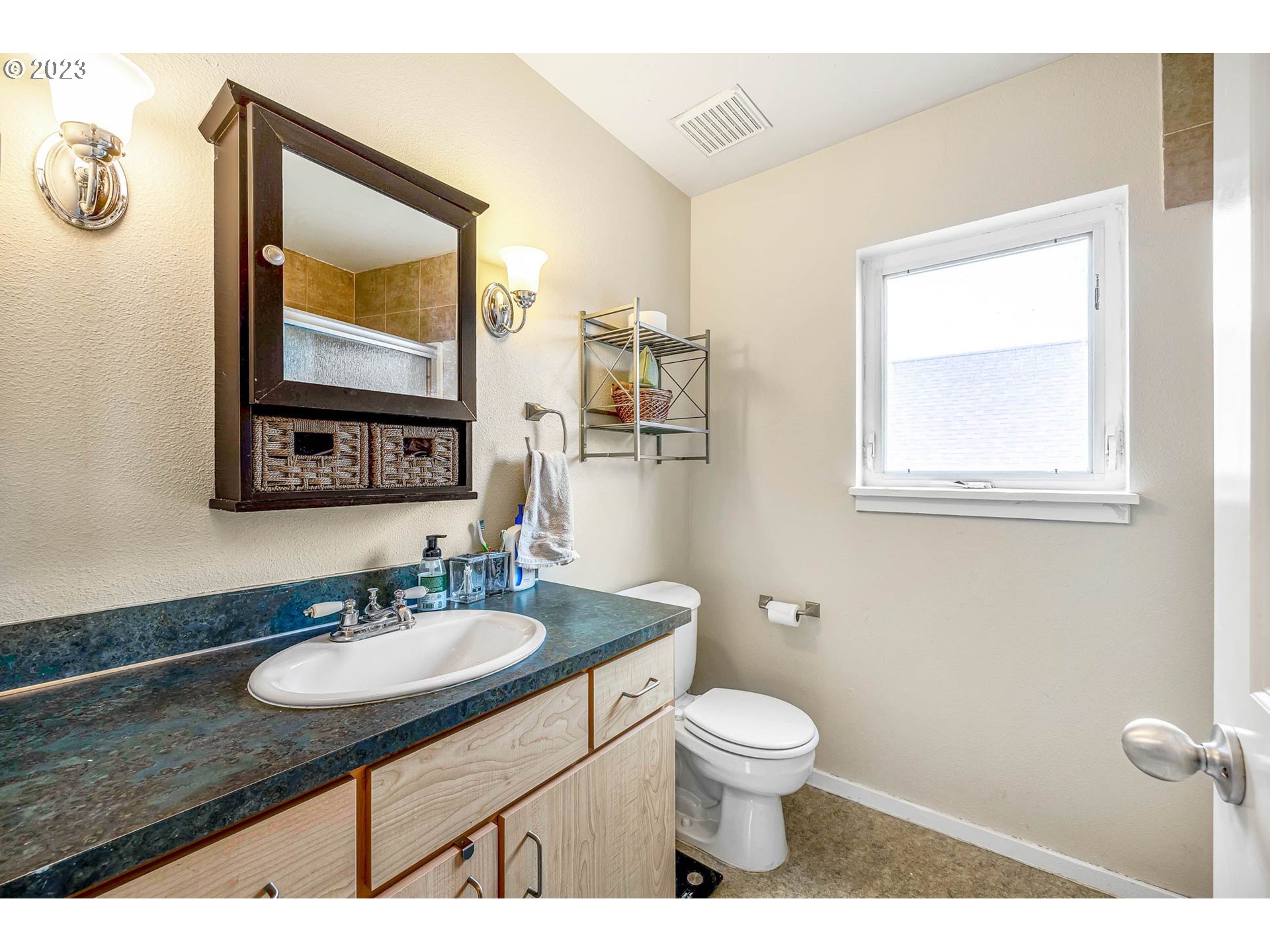 1709 Fairhaven Drive Springfield, OR 97477 - Photo 16 of 26 a bathroom with a toilet sink vanity and mirror