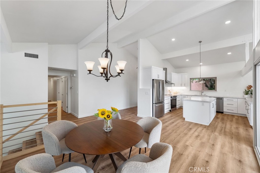 41070 Avenida Verde Temecula, CA 92591 - Photo 11 of 70 a living room with kitchen island furniture and a chandelier