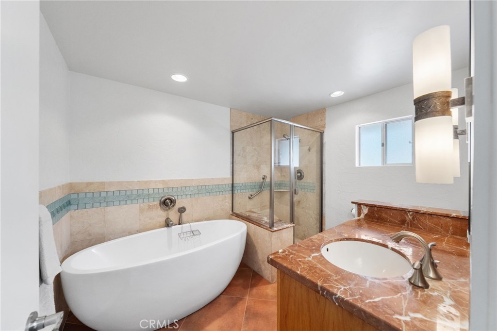 41070 Avenida Verde Temecula, CA 92591 - Photo 34 of 70 a bathroom with a granite countertop sink and a mirror