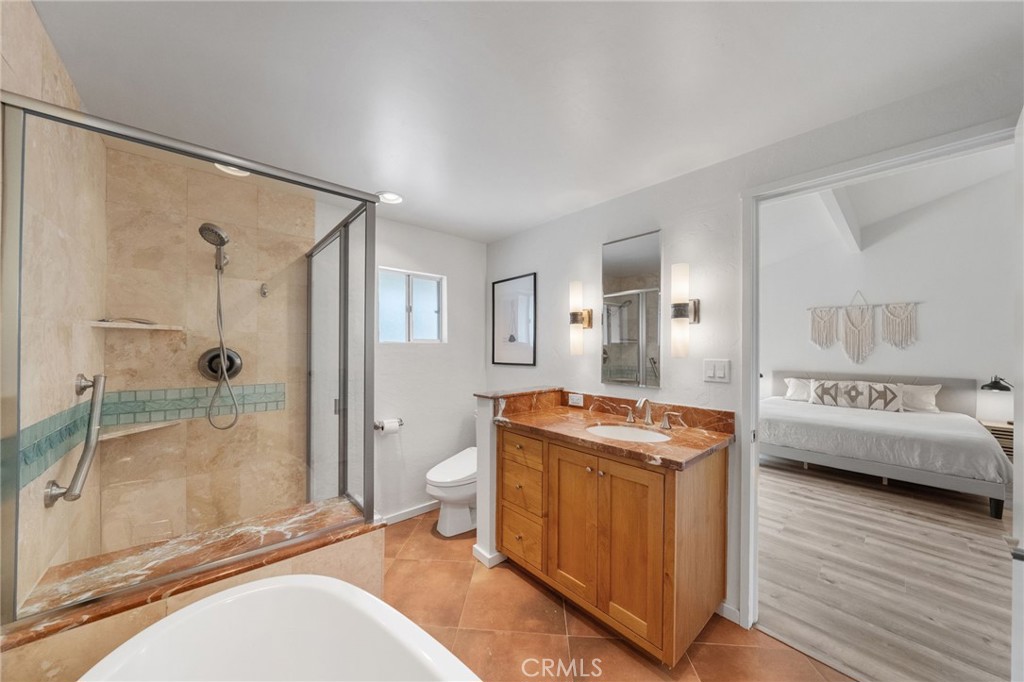 41070 Avenida Verde Temecula, CA 92591 - Photo 35 of 70 a spacious bathroom with a granite countertop sink mirror toilet and bathtub
