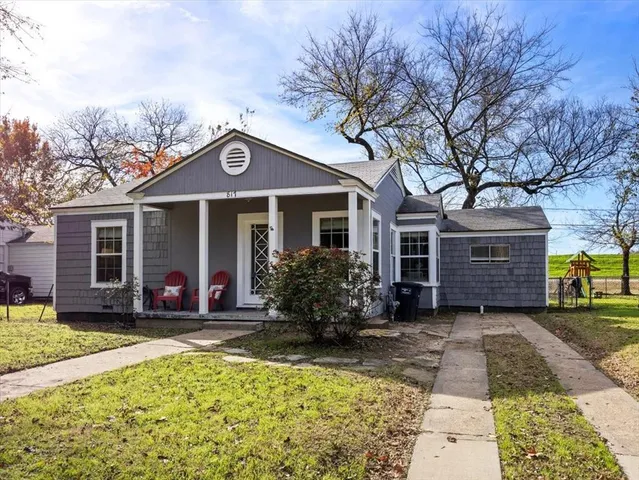 a front view of a house with a garden and porch