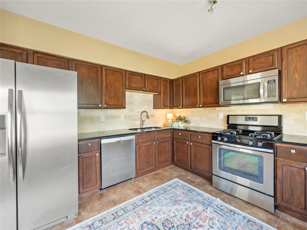 817 Edgefield Road Fort Worth, TX 76107 - Photo 8 of 15 Chef's kitchen with dark wood cabinets